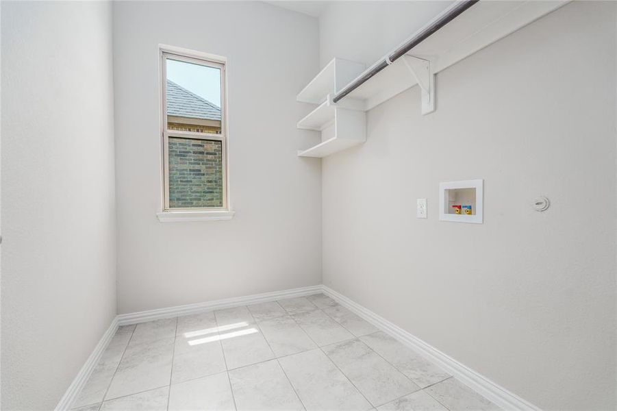 Laundry room featuring tile patterned flooring, washer hookup, and hookup for a gas dryer