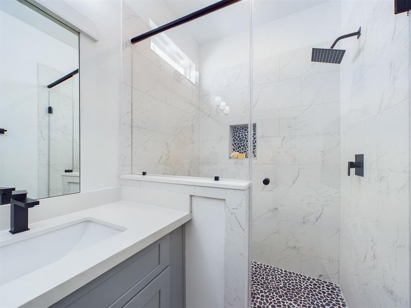 Primary Bathroom features a gorgeous shower with semi-frameless glass shower door.