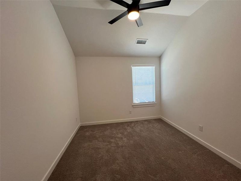 Carpeted empty room with ceiling fan