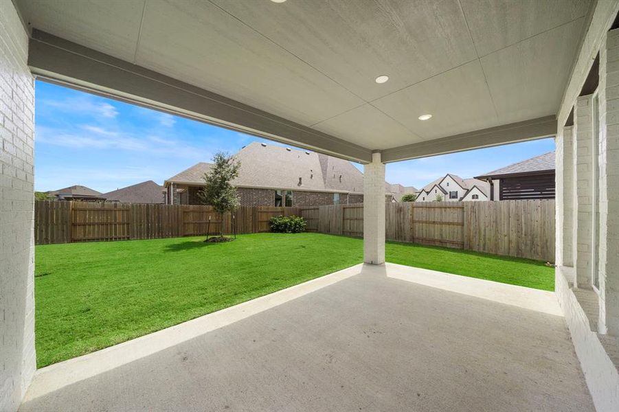 Covered patio includes gas stub for outdoor grill, power outlet for TV, and overhead wiring for fans.