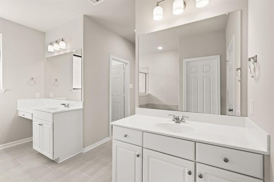 The en-suite bathroom offers a spa-like atmosphere with its elegant design, high end finishes, and tasteful lighting, creating a retreat within your own home.