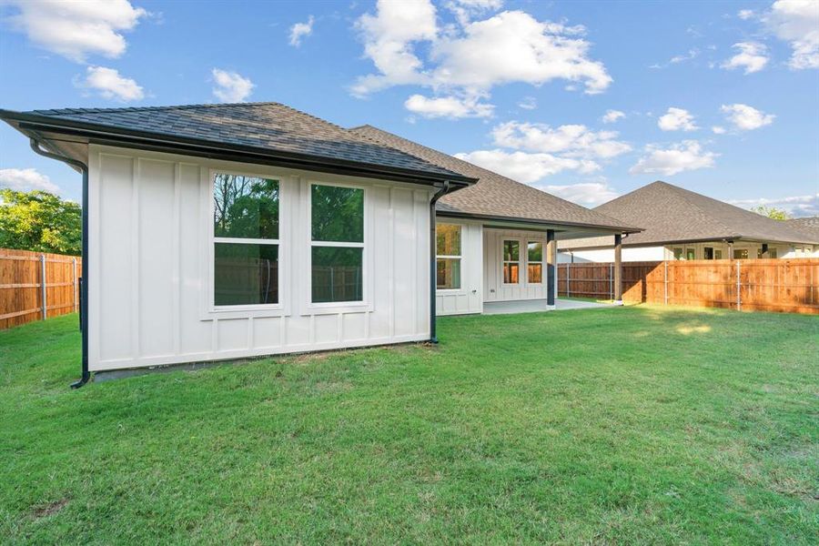 Back of house featuring a yard