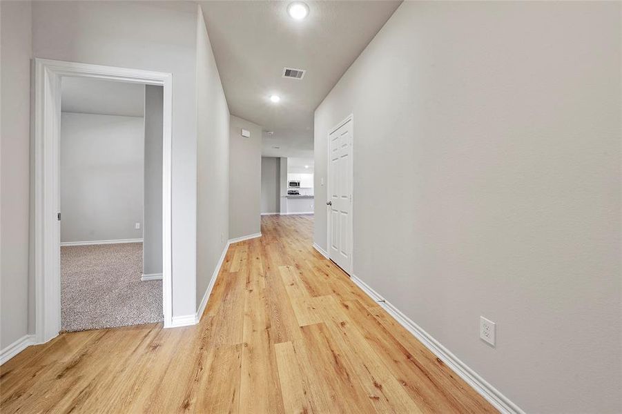 Nice entry way wit art gallery wall leading to the living area