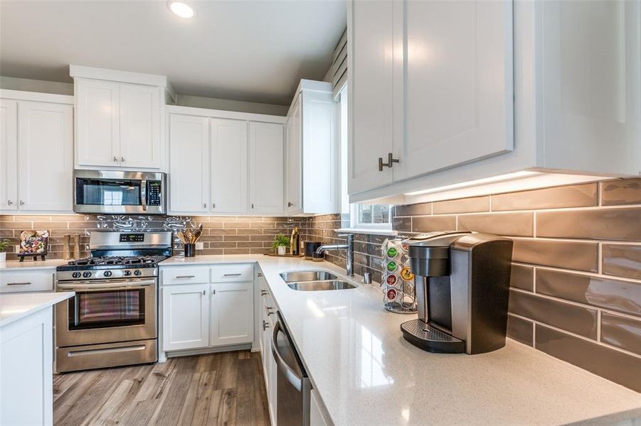 Gorgeous cabinets, beautiful stainless appliances, quartz counters, under cabinet lighting....what more could you ask for in a dream kitchen?