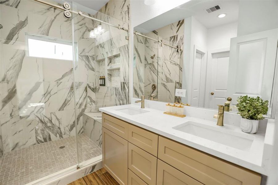 Luxurious primary bathroom with private toilet room and walk-in closet