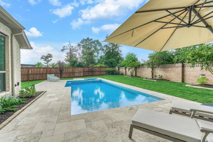 Aesthetically-pleasing, brick-lined privacy fence and mature landscaping is a plus - an ideally tranquil setting!