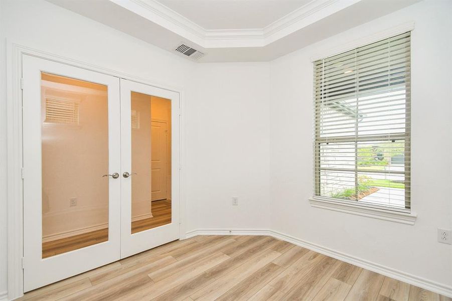 Impressive french doors entrance the flex/study room with lovely Tray Ceiling