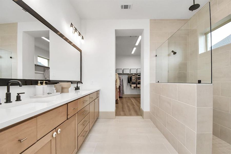 Primary ensuite with dual sinks and builder upgrade "super" shower with dual shower heads. Ensuite connects to closet.