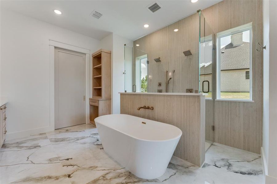 Bathroom featuring vanity, a tub to relax in, and tile patterned flooring