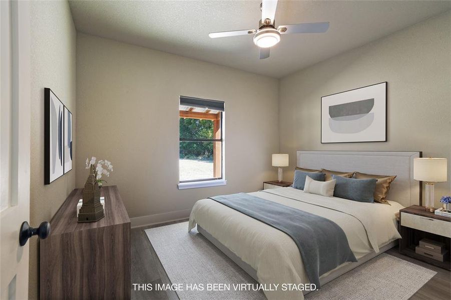 Bedroom featuring ceiling fan and hardwood / wood-style flooring