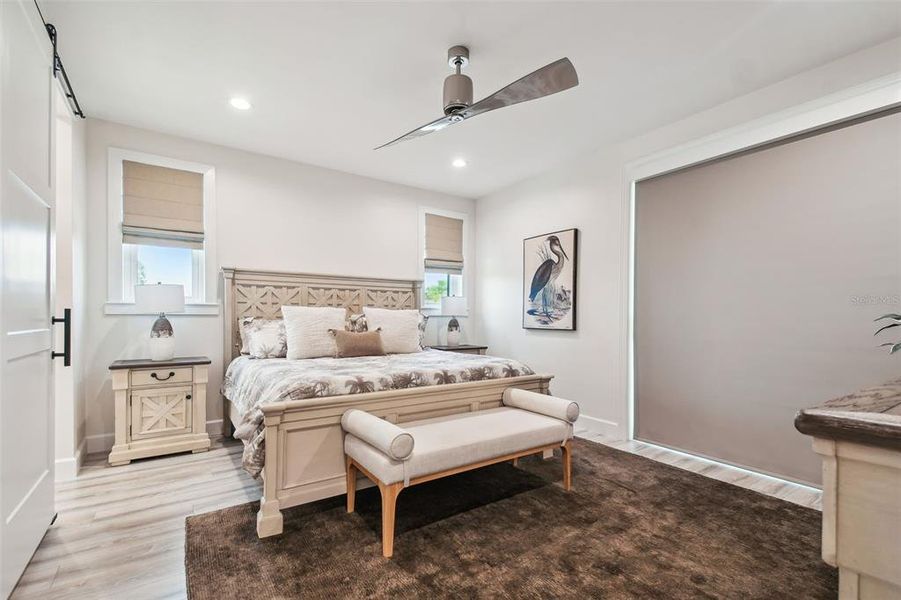 Primary bedroom with sliding glass doors to lanai and remote controlled shade.