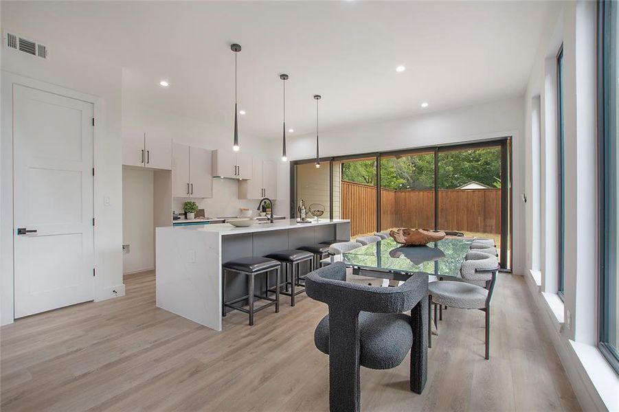 Dining space featuring light hardwood / wood-style flooring and sink