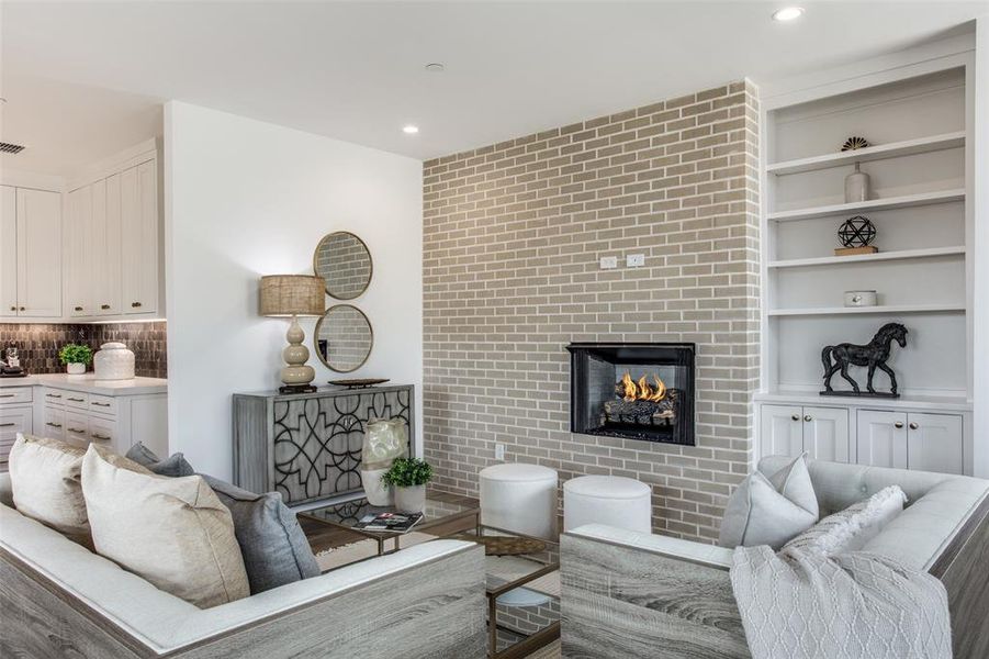 Living room with built in shelves and hardwood / wood floors