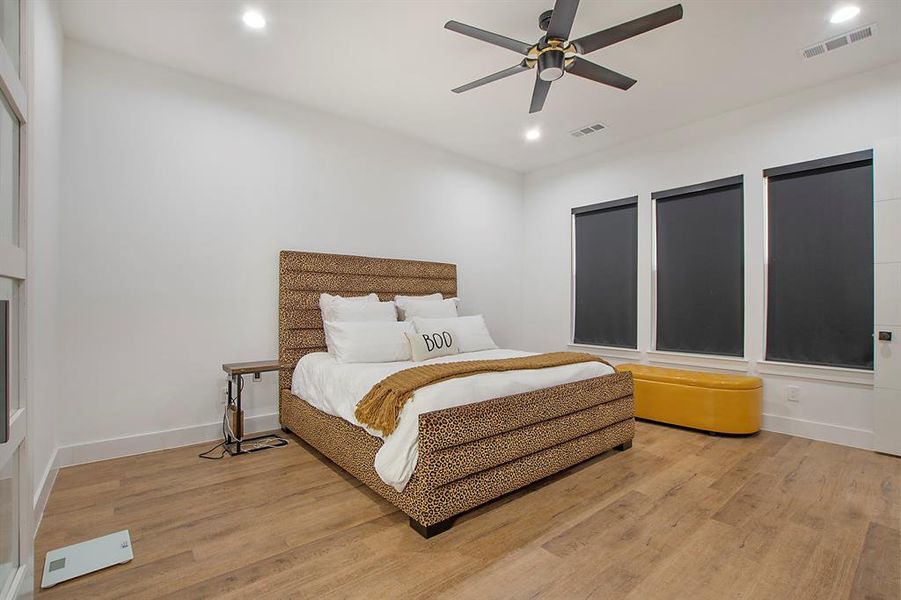 Bedroom featuring ceiling fan and wood-type flooring