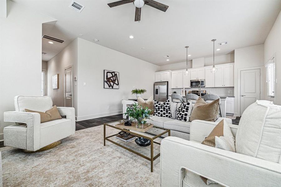 The open concept on the first floorseamlessly connects the living,diving and kitchen areas.