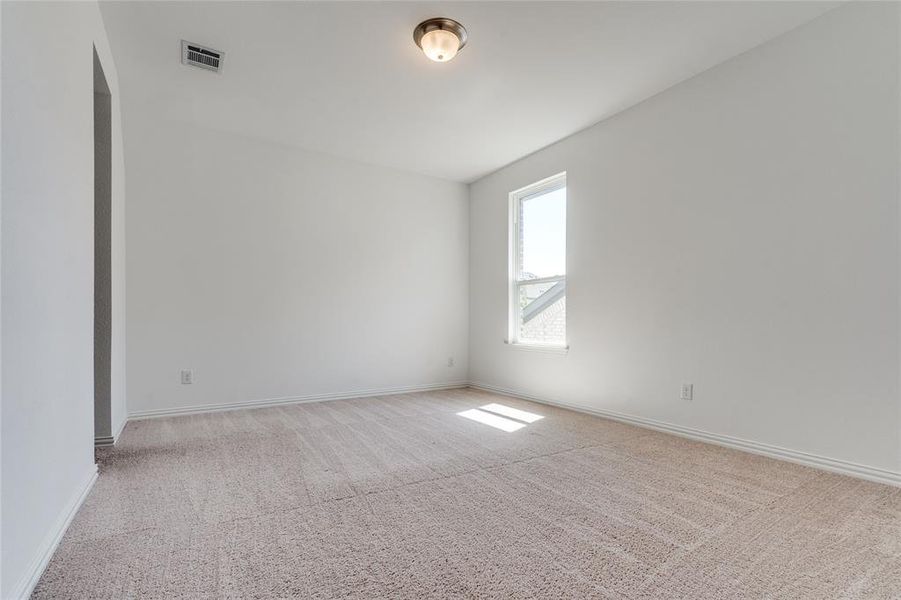 Spare room with light colored carpet