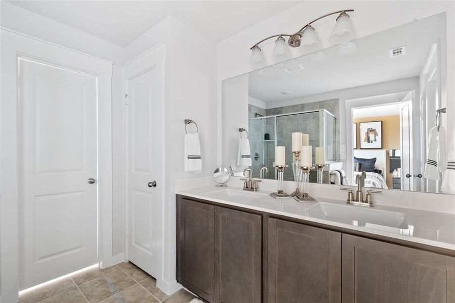 Bathroom featuring vanity, an enclosed shower, and tile patterned floors