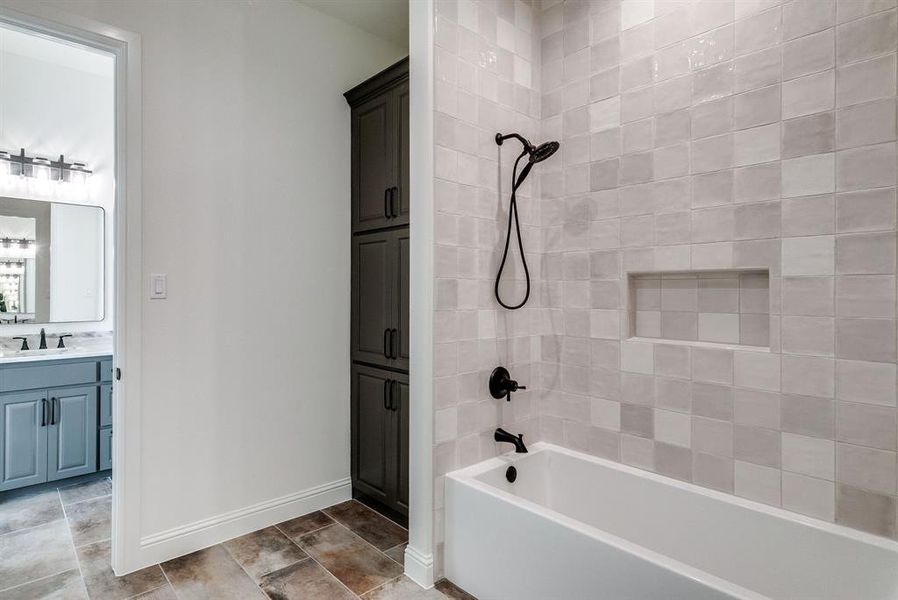 Bathroom with vanity and tiled shower / bath combo