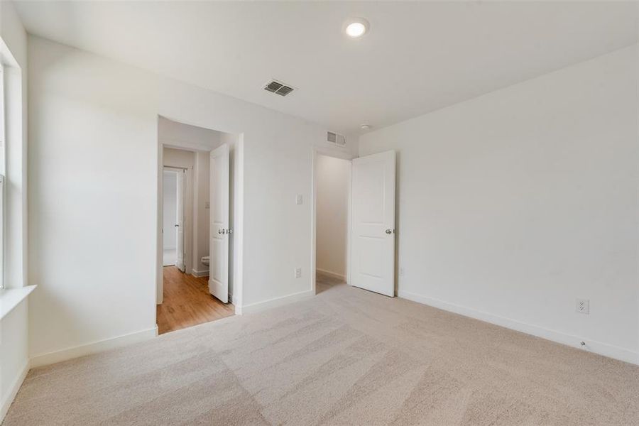 Unfurnished bedroom featuring light carpet