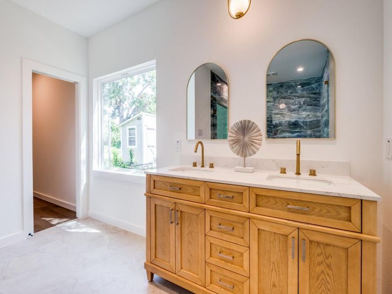 Bathroom featuring vanity and a shower