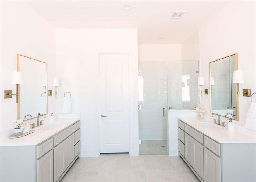 Bathroom featuring walk in shower, vanity, and tile patterned floors