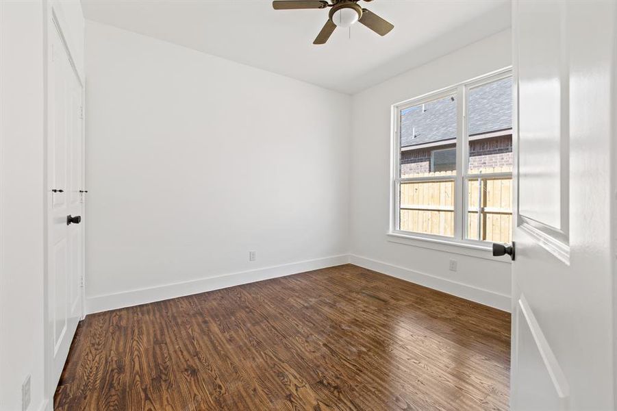 Spare room featuring hardwood / wood-style floors and ceiling fan