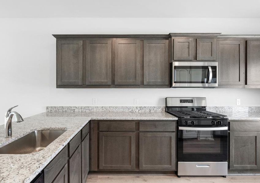 The kitchen has gorgeous wood cabinetry.