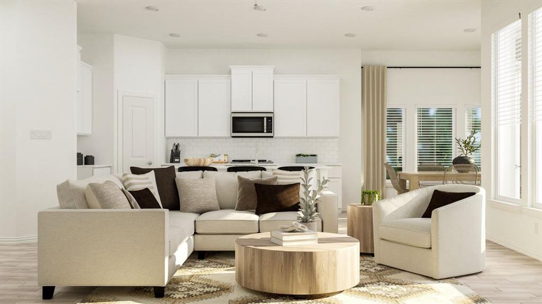 Living room with a healthy amount of sunlight and light wood-type flooring