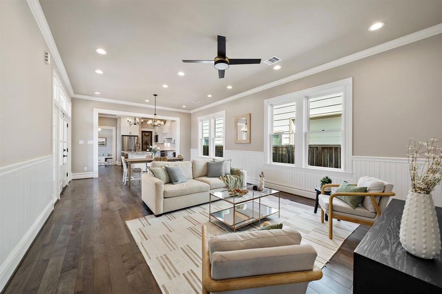 Step into the open plan Living - Dining - Kitchen spaces! The wainscoting detail continues into this space. SOLID HICKORY hardwood floors throughout!