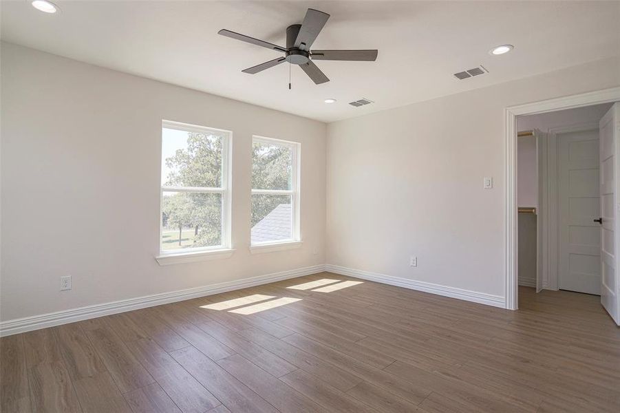 Unfurnished room featuring hardwood / wood-style flooring and ceiling fan