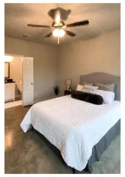 Bedroom featuring ensuite bath and ceiling fan