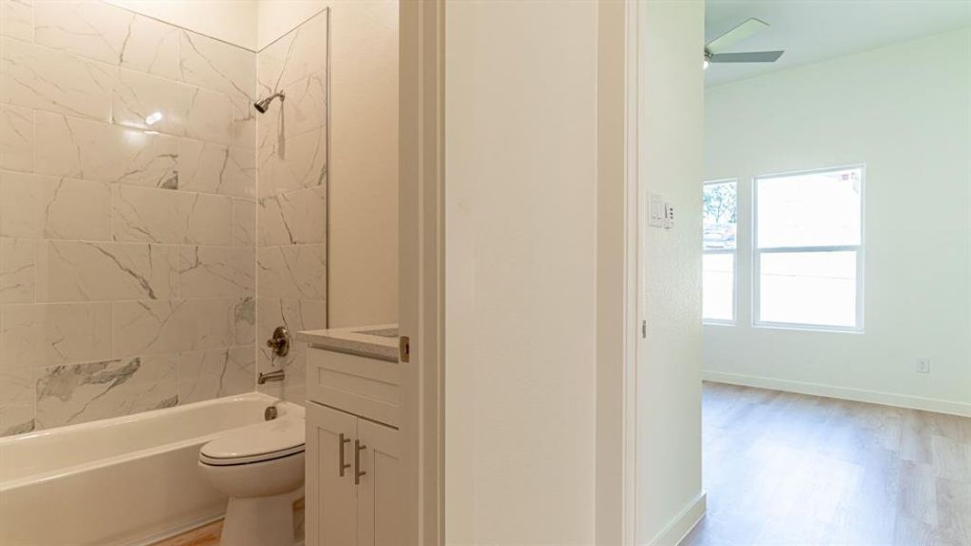 Second bathroom with tiled shower/tub combo