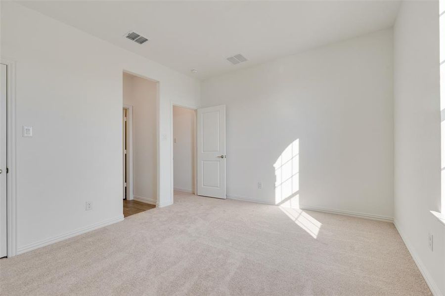 Unfurnished room featuring light carpet