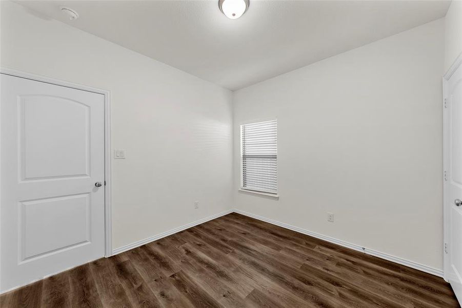 Spare room with dark hardwood / wood-style floors