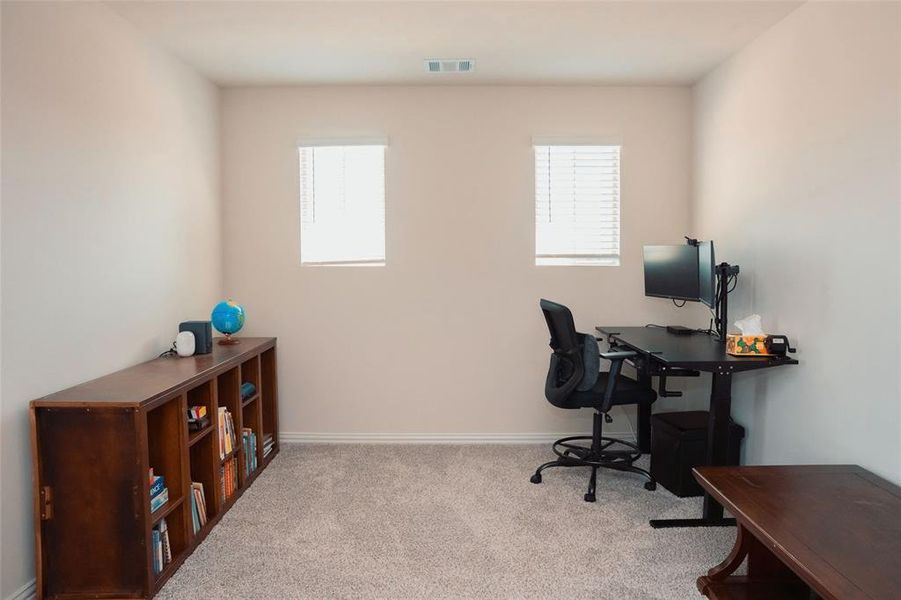 Office space featuring light colored carpet