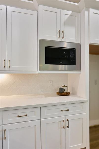 Attention to detail surrounds this home with a flush framed ss microwave.