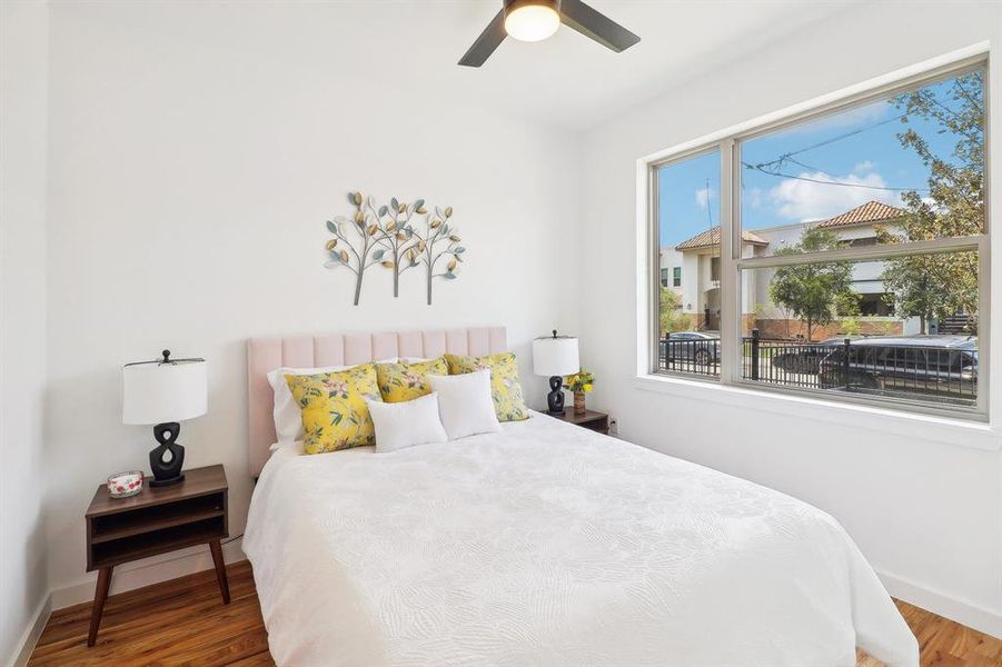 Bedroom featuring wood-type flooring and ceiling fan