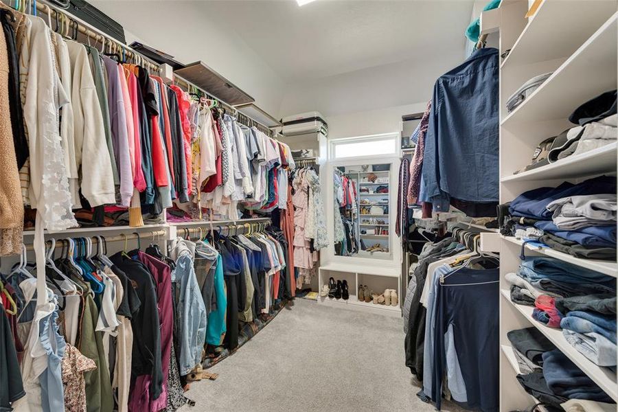 Spacious closet with light carpet