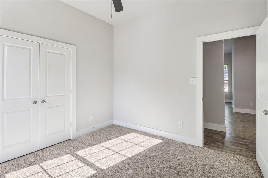 Unfurnished bedroom featuring ceiling fan, light wood-type flooring, and a closet