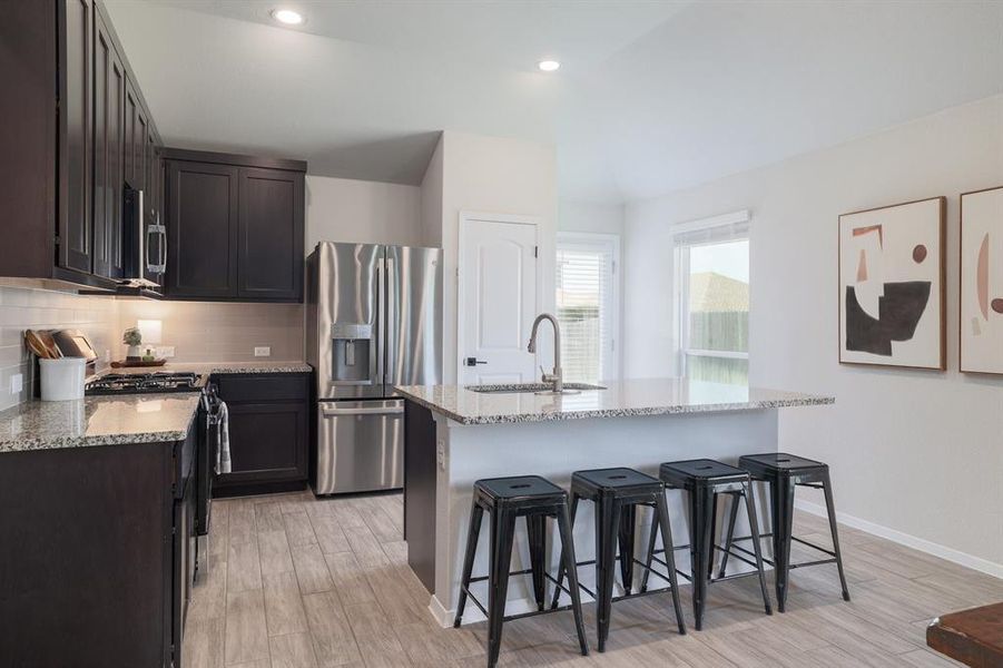 Chef's kitchen equipped with a center island, ideal for meal prep and casual dining.