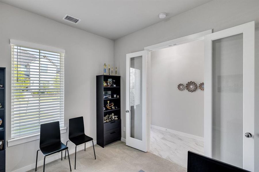 Sitting room with light carpet, french doors, and plenty of natural light