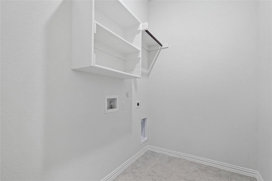 Laundry area with hookup for a washing machine, gas dryer hookup, and electric dryer hookup