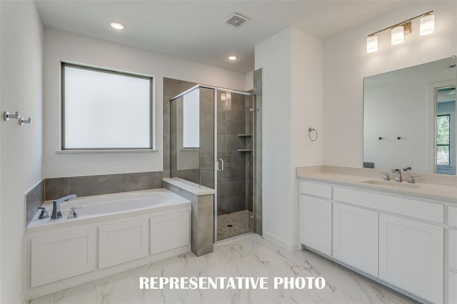 This fantastic owner's bath offers a spacious walk in shower combined with a wonderful garden tub.  REPRESENTATIVE PHOTO