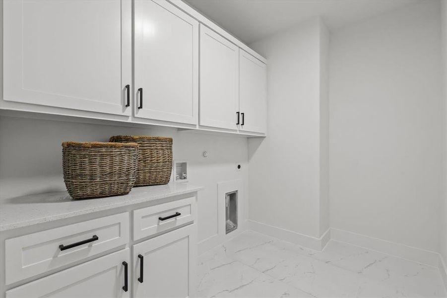 Laundry area with washer hookup, cabinets, hookup for an electric dryer, and hookup for a gas dryer