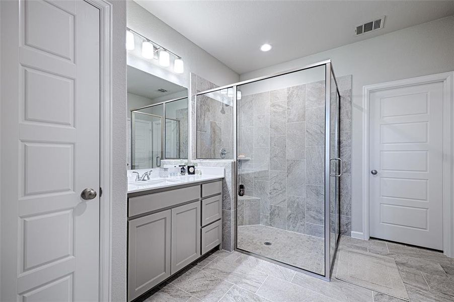 Master Bath with dual vanities and an enclosed shower