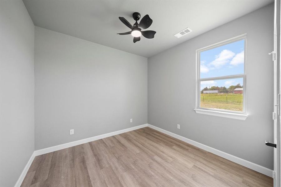 Spare room with light hardwood / wood-style floors and ceiling fan