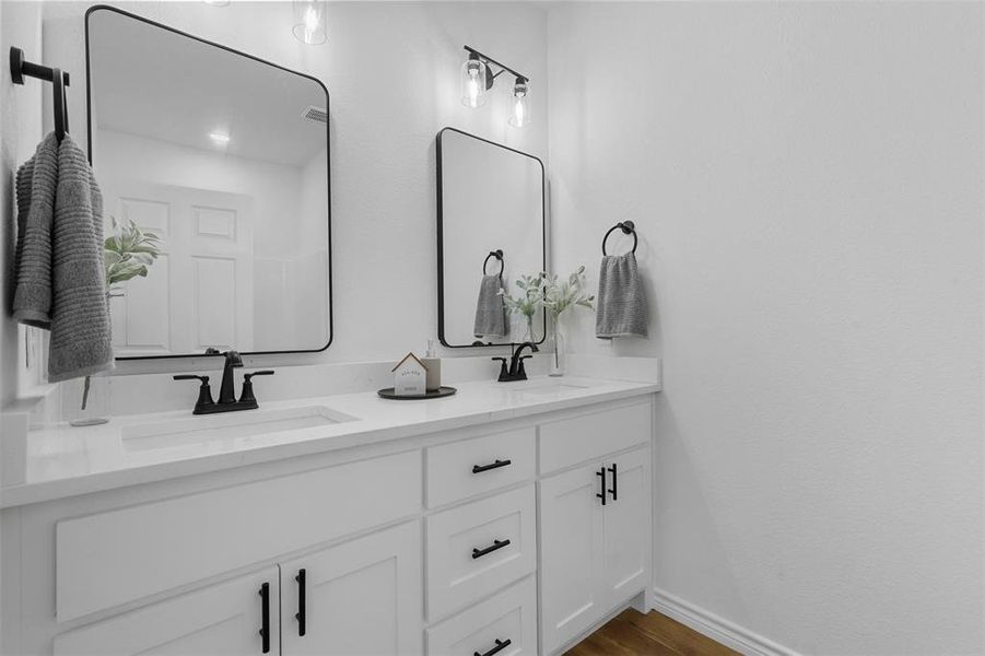 Bathroom featuring vanity and hardwood / wood-style floors