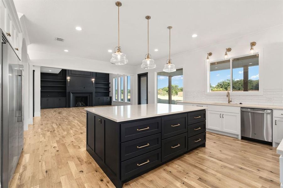 Loads of storage in the kitchen and really beautiful hardware and lighting choices.