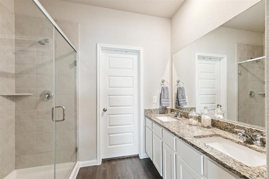 Oversized shower with tile surround, double sinks and plenty of storage. There is also a large closet to accommodate all of your needs.