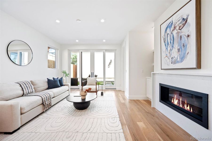 Airy living room with central fireplace and wide sliding glass door